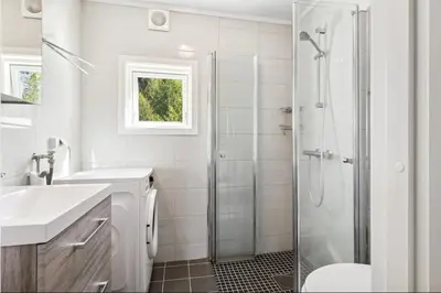 a bathroom with a shower and a toilet and a sink at Family & Friends Space in Råholt in Lii