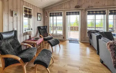 a living room with a couch and chairs and a table at Gorgeous Home In Sjusjøen With Sauna in Sjusjøen