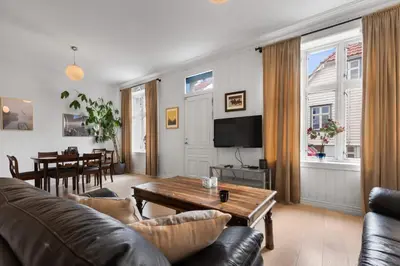 a living room with a couch and a table at Unique and Spacious Home in Bergens Most Charming Area in Bergen
