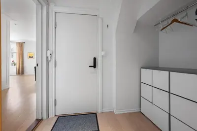 a white kitchen with a door and a rug at Unique and Spacious Home in Bergens Most Charming Area in Bergen