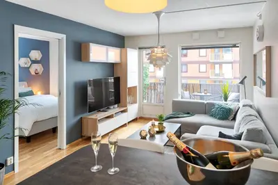 a living room with a couch and a tv at Cozy apartment Trondheim, free parking in the basement in Trondheim