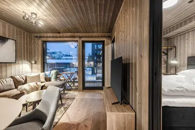 a bedroom and living room with a bed and a couch at Fritidsbolig i Hemsedal in Kyrkjebøen