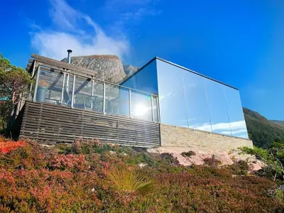 a glass house on top of a hill at Speilhus med badestamp - en unik naturopplevelse in Solem
