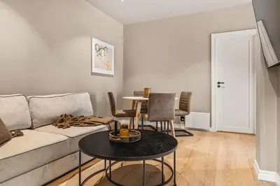 a living room with a couch and a table at Hardanger Odda Apartments in Odda