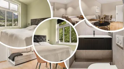 a bedroom with two beds and a mirror at Hardanger Odda Apartments in Odda