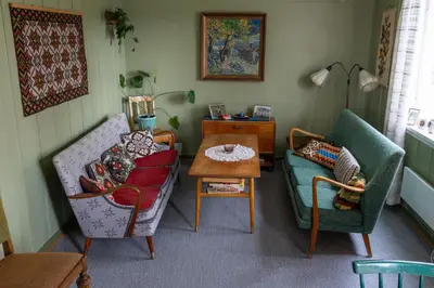 a living room with two chairs and a table at Voi Voi Bed & Breakfast in Røros