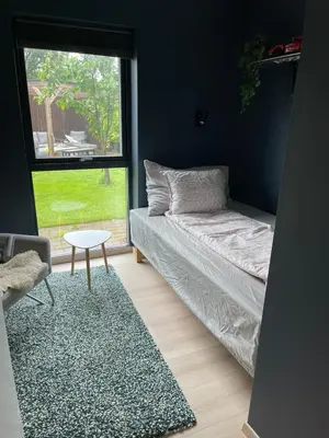 a living room with a couch and a table and a window at Modern house - perfect for holidays in Bergen in Bergen