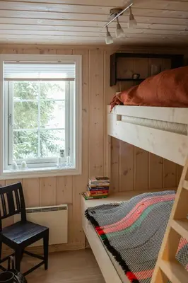 a bedroom with a bunk bed and a window at Authentic Family Cabin Experience At Sjusjøen in Sjusjøen