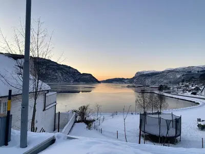 a view of a river with snow on the ground at The View in Sauda