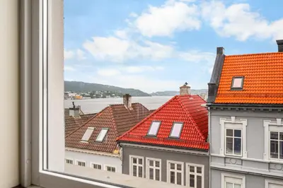 a view of roofs from a window of a building at Central & Modern Apartment in the Coziest Street in Bergen in Bergen