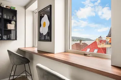 a window in a room with a counter and a chair at Central & Modern Apartment in the Coziest Street in Bergen in Bergen