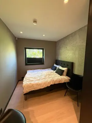 a bedroom with a large bed and a window at Villa Vaaganeset in Lii