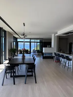 a dining room and living room with a table and chairs at Villa Vaaganeset in Lii