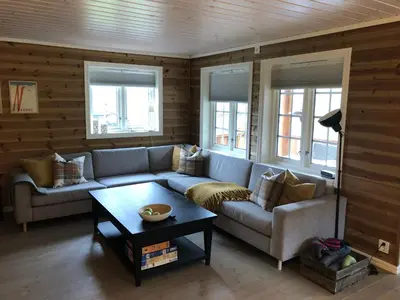a living room with a couch and a coffee table at Familiehytte på Kvamskogen in Kvam