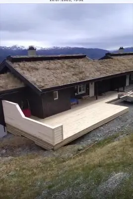 a house with a large deck in front of it at Flott leilighet på Voss i Tråstølsvegen med 3 soverom 6 sengeplasser in Skulestadmo