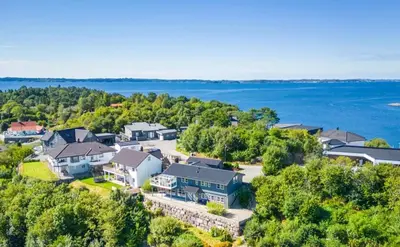 an aerial view of a home with the water in the background at Colorful family apartment near the sea - boat for rent