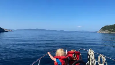 two children on a boat in the water at Colorful family apartment near the sea - boat for rent