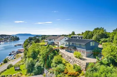 an aerial view of a house on a hill next to the water at Colorful family apartment near the sea - boat for rent