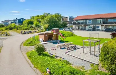 a park with a playground with a swing at Colorful family apartment near the sea - boat for rent
