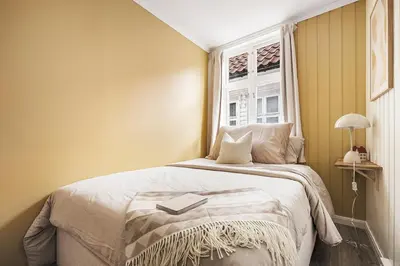 a bedroom with a bed with a book on it at Bergen pearl in historic street & easy check-in in Bergen