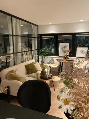 a living room with a couch and tables and windows at Holiday apartment south Norway in Lii