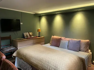 a bedroom with a bed and a flat screen tv at Villa chaimae in Lii