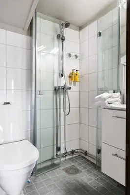 a bathroom with a shower with a toilet and a sink at Cozy Skilodge ski in & out in Trysil in Trysil