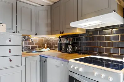 a kitchen with white cabinets and a stove top oven at Cozy Skilodge ski in & out in Trysil in Trysil