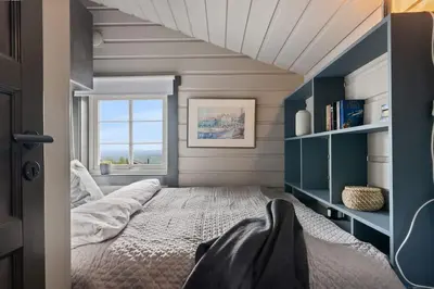a bedroom with a large bed and a window at Cozy Skilodge ski in & out in Trysil in Trysil