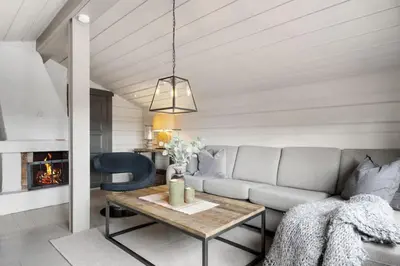 a living room with a couch and a table at Trysilfjell Nord 1105C - by Vacation Trysil in Trysil