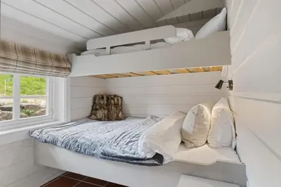 a small bedroom with a bed and a window at Trysilfjell Nord 1105C - by Vacation Trysil in Trysil