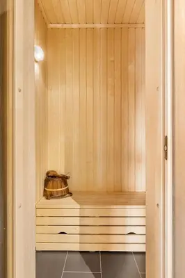 a sauna with a kettle on a wooden shelf at Trysilfjell 24 by Vacation Trysil in Trysil