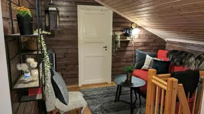 a living room with a couch and a table at Ski-In, Ski-Out apartment at Filefjell in Tyinkrysset