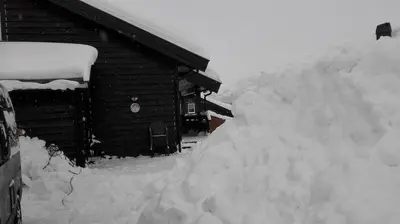 a pile of snow in front of a cabin at Ski-In, Ski-Out apartment at Filefjell in Tyinkrysset