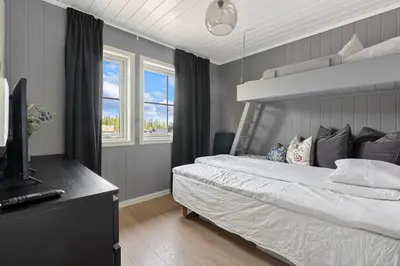 a bedroom with a large bed and a television at Trysilfjell 786 by Vacation Trysil in Trysil