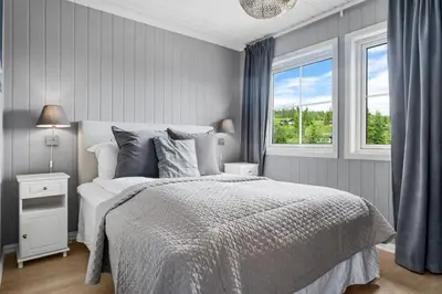 a white bedroom with a bed and a window at Trysilfjell 786 by Vacation Trysil in Trysil