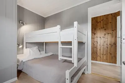 a bedroom with a white bunk bed with a ladder at Trysilfjell 786 by Vacation Trysil in Trysil