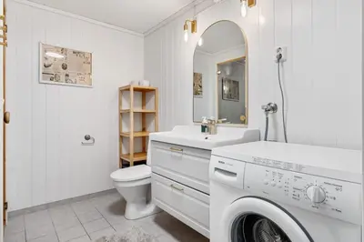a white bathroom with a sink and a washing machine at Trysilfjell 782 by Vacation Trysil in Trysil