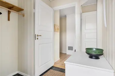 a white kitchen with a green bowl on top of a cabinet at Trysilfjell 782 by Vacation Trysil in Trysil