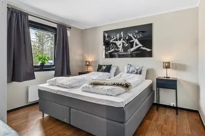 a bedroom with a large bed with white sheets at Trysilfjell 33 by Vacation Trysil in Trysil