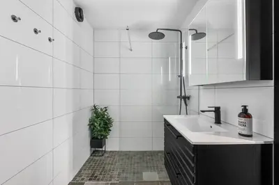 a white bathroom with a sink and a shower at Trysilfjell 33 by Vacation Trysil in Trysil