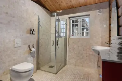 a bathroom with a shower and a toilet and a sink at Trysilfjell 636 by Vacation Trysil in Trysil