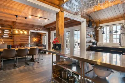 a kitchen with a long counter and a dining room at Trysilfjell 636 by Vacation Trysil in Trysil