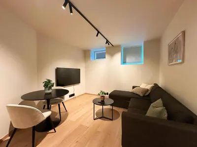 a living room with a couch and a table at Aurum Bergen Apartment in Bergen