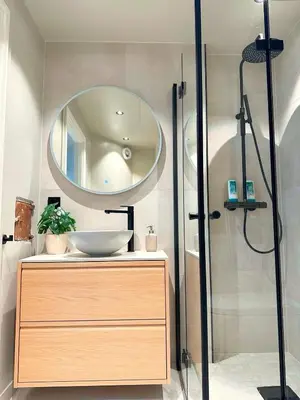 a bathroom with a sink and a mirror at Aurum Bergen Apartment in Bergen