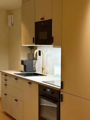 a kitchen with a sink and a microwave at Aurum Bergen Apartment in Bergen