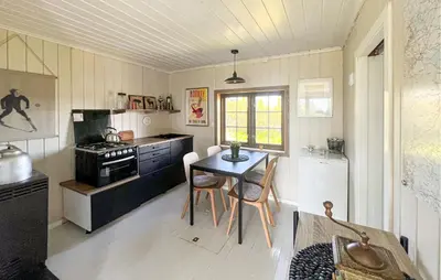 a kitchen with a table and chairs in a room at 3 Bedroom Stunning Home In Lillehammer in Lillehammer