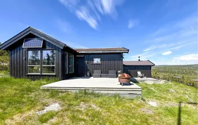 a black house on top of a grassy hill at 3 Bedroom Stunning Home In Lillehammer in Lillehammer