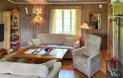 a living room with a couch and two chairs and a table at 2 Bedroom Nice Home In Hafjell in Hafjell