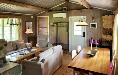 a living room with a couch and a wooden table at 2 Bedroom Nice Home In Hafjell in Hafjell
